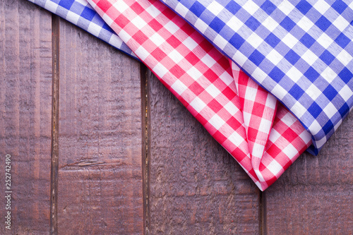 blue and red kitchen cloths on wood