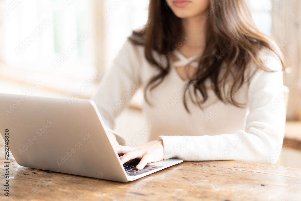 attractive asian woman using laptop in living room attractive asian woman using laptop in living room