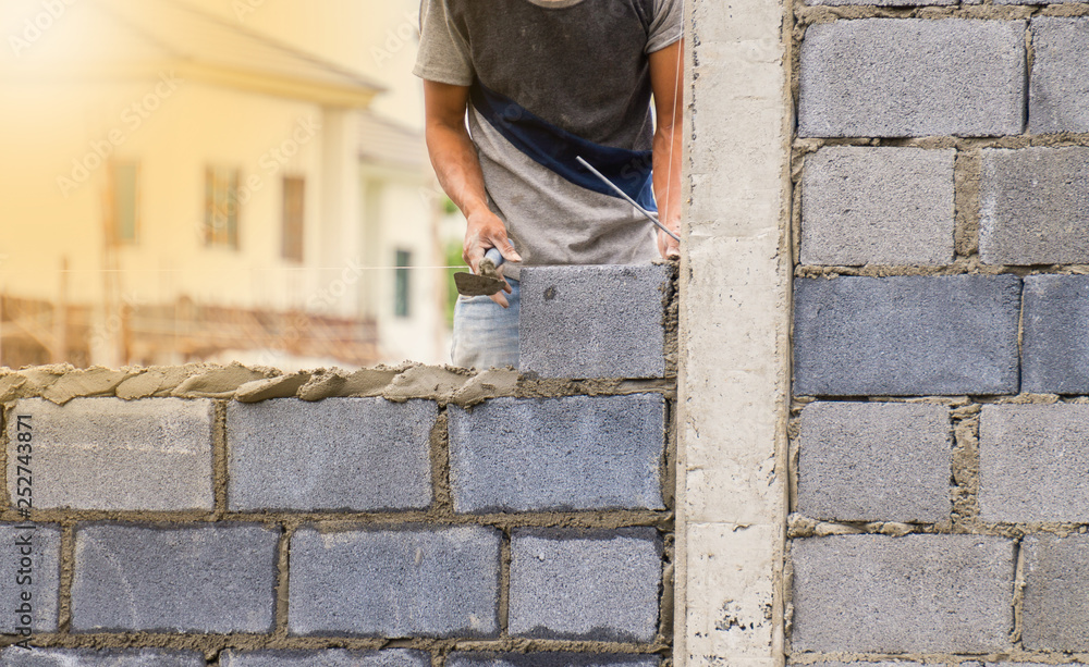 Construction workers are working on building a wall for the village. Construction workers are working on building a wall for the village.