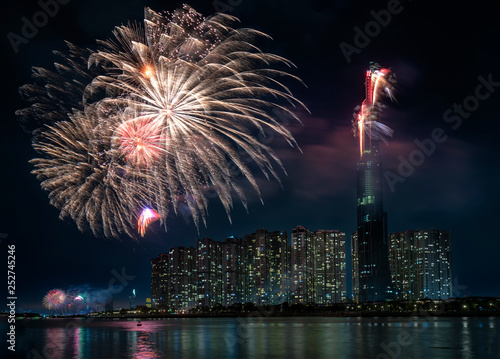 Ho Chi Minh City, Vietnam - February 4th, 2019: Colorful fireworks welcome lunar new year view from skyscraper at night. This is tallest building in Vietnam and top 10 tallest buildings in the world photo