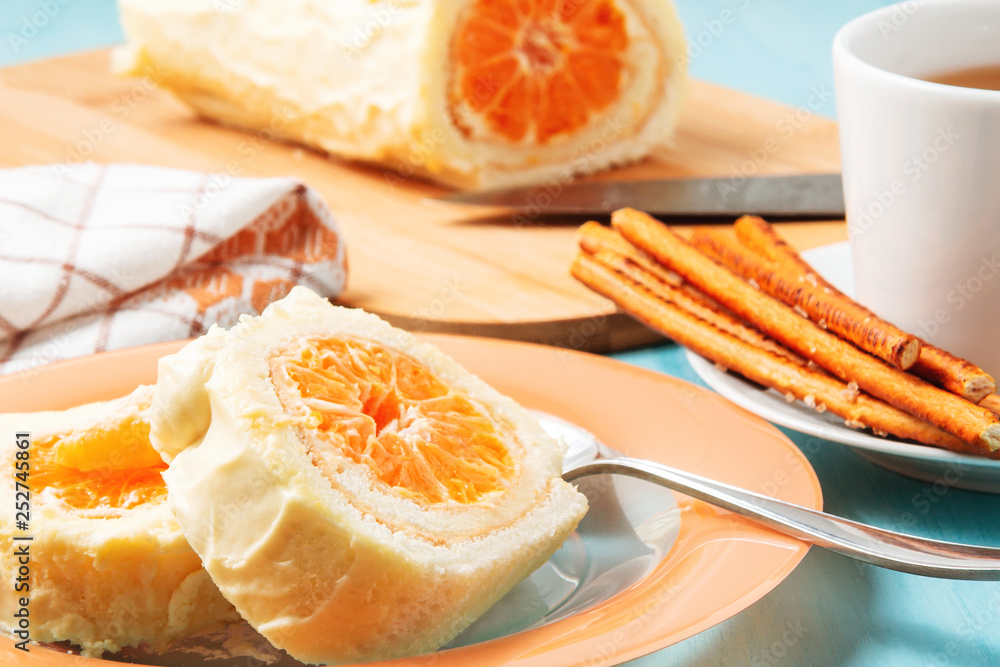 Sweet roll with whipped cream and tangerine filling and a cup of coffee Sweet roll with whipped cream and tangerine filling and a cup of coffee