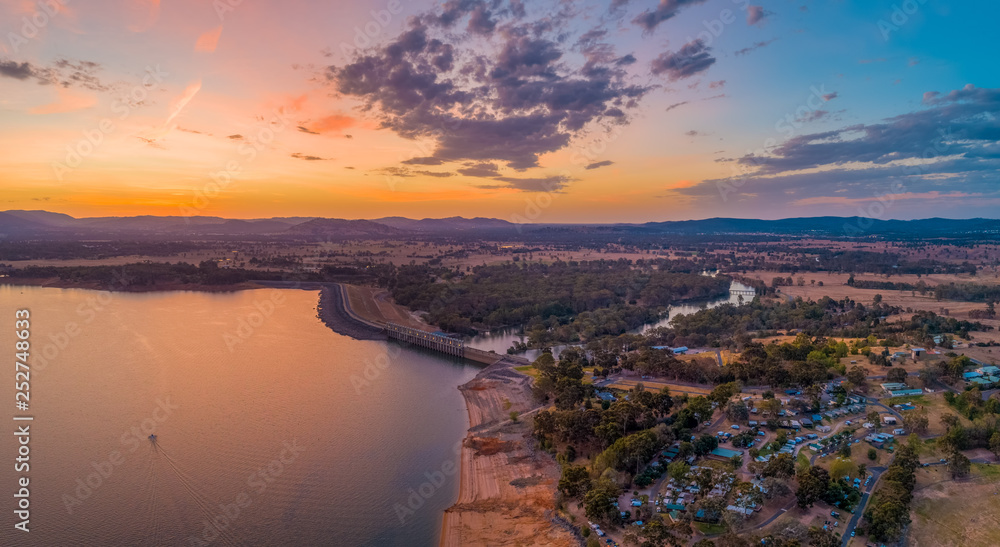 Lone boat sailing across Lake Hume near the Dam at twilight aerial