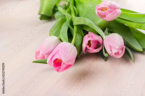 Fototapeta Naklejka Na Ścianę i Meble -  Pink tulips bouquet on wooden table. Women's day natural background