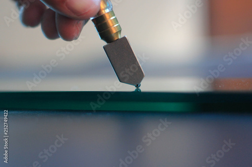 Glass technicians are cutting thick glass from the factory. photo