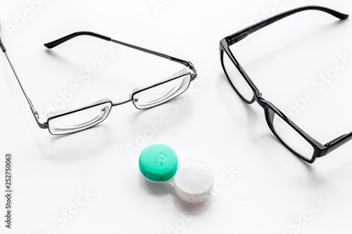 Eye problems. Glasses with transparent lenses and contact lenses on white background
