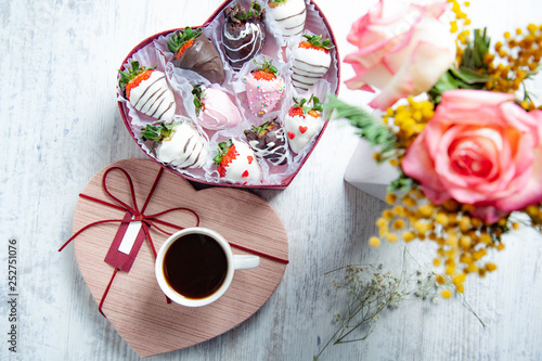 chocolate strawberries with coffee and flowers photo