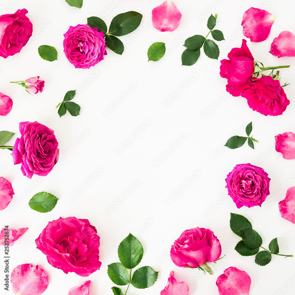 Round frame of pink ranunculus flowers, roses and leaves on white background. Floral lifestyle composition. Flat lay, top view.