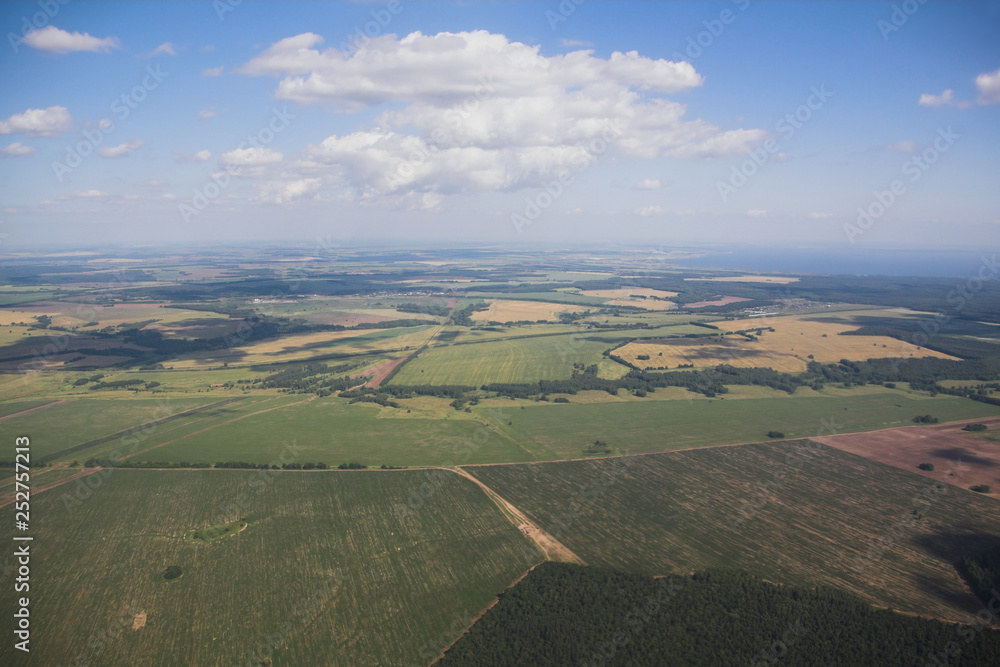Naklejka premium Agricultural fields and sky, view from plane. Kazan, Russia