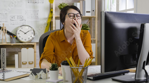 Vászonkép sleepy tired overworked hardworking assistant architect yawning with close eyes cover mouth want to sleep