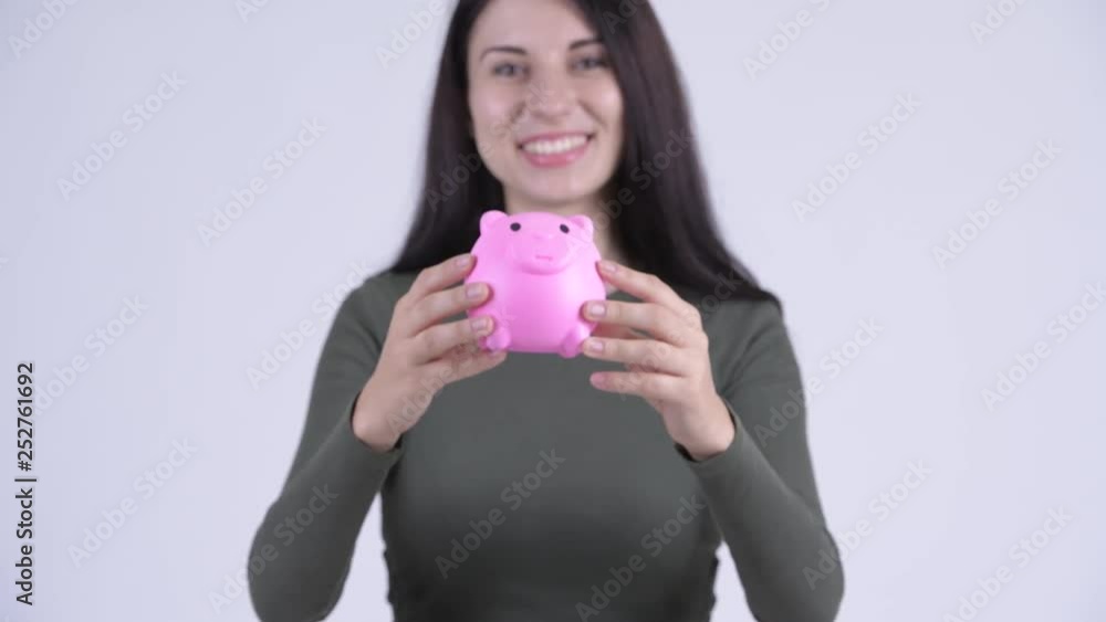 Happy young beautiful woman giving piggy bank Happy young beautiful woman giving piggy bank