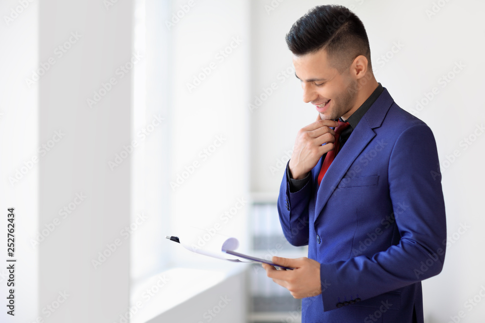 Happy businessman reading contract in the office Happy businessman reading contract in the office