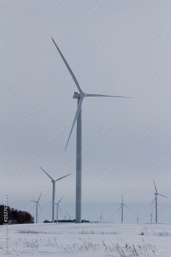 Electric wind turbines on a snowy rural field in winter Electric wind turbines on a snowy rural field in winter