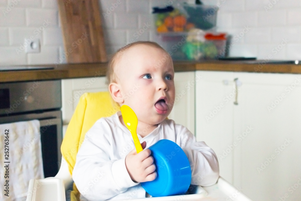 baby eat from blue plates with a yellow spoon baby eat from blue plates with a yellow spoon