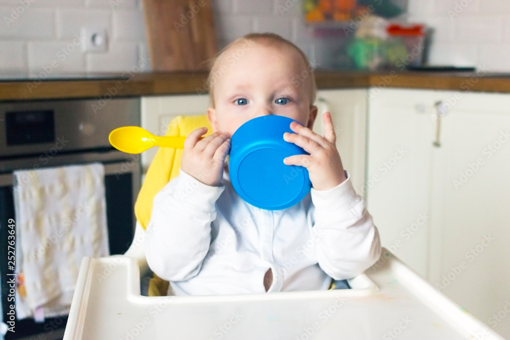 baby eat from blue plates with a yellow spoon baby eat from blue plates with a yellow spoon