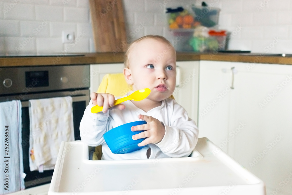 baby eat from blue plates with a yellow spoon baby eat from blue plates with a yellow spoon