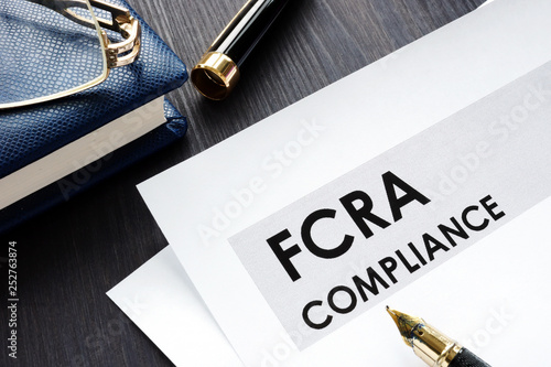 FCRA compliance form on a wooden desk. photo