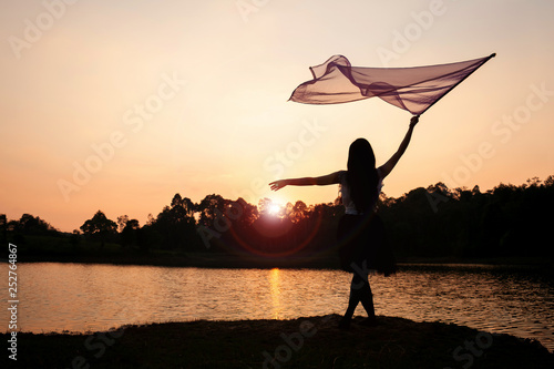 Girl Worship Jesus with Flag Dance in the Sunset at the River