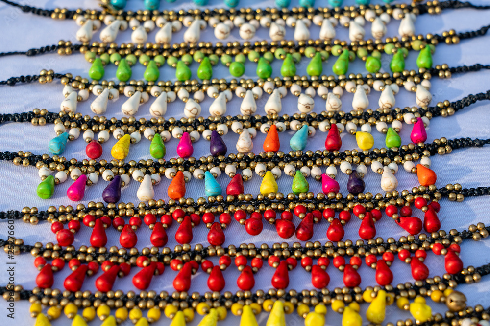 Colorful bracelets for sale on street at night market, Thailand. Souvenirs for tourists at market , close up