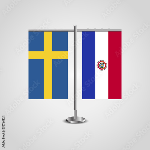 Table stand with flags of Sweden and Paraguay.Two flag. Flag pole. Symbolizing the cooperation between the two countries. Table flags