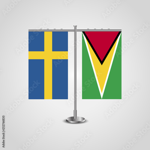 Table stand with flags of Sweden and Guyana.Two flag. Flag pole. Symbolizing the cooperation between the two countries. Table flags