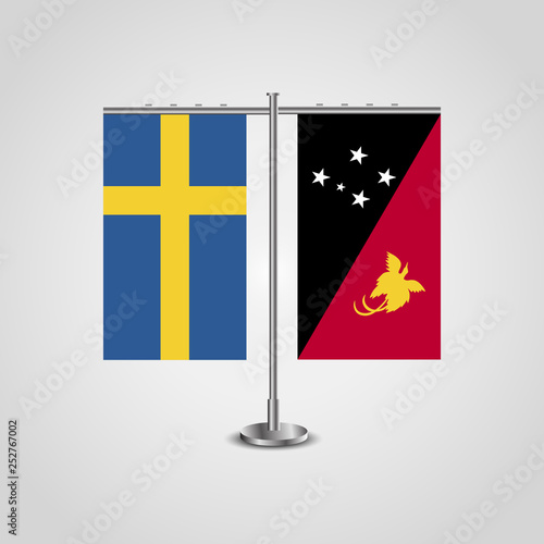 Table stand with flags of Sweden and Papua New Guinea.Two flag. Flag pole. Symbolizing the cooperation between the two countries. Table flags