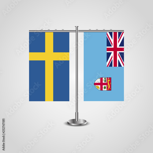 Table stand with flags of Sweden and Fiji.Two flag. Flag pole. Symbolizing the cooperation between the two countries. Table flags