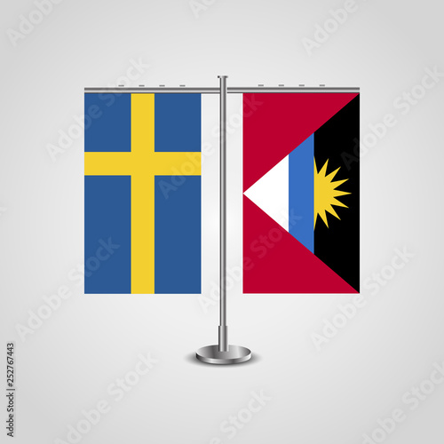 Table stand with flags of Sweden and Antigua and Barbuda.Two flag. Flag pole. Symbolizing the cooperation between the two countries. Table flags