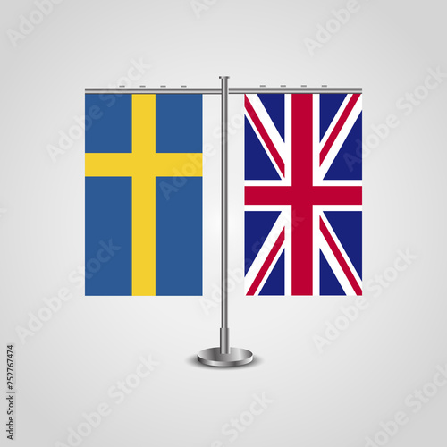 Table stand with flags of Sweden and United Kingdom.Two flag. Flag pole. Symbolizing the cooperation between the two countries. Table flags