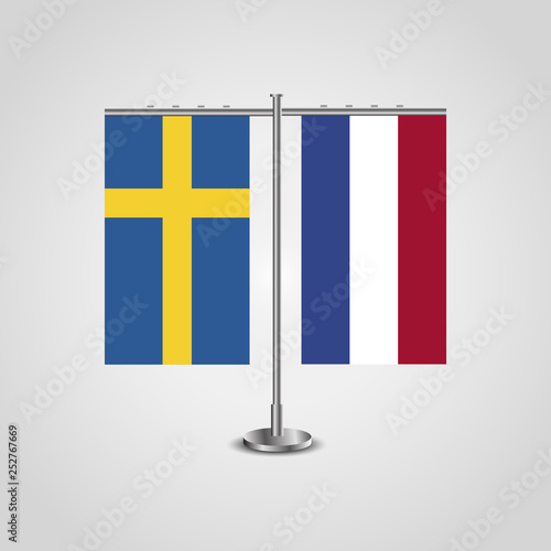 Table stand with flags of Sweden and Netherlands.Two flag. Flag pole. Symbolizing the cooperation between the two countries. Table flags