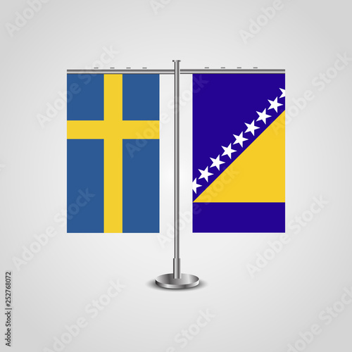 Table stand with flags of Sweden and Bosnia and Herzegovina.Two flag. Flag pole. Symbolizing the cooperation between the two countries. Table flags
