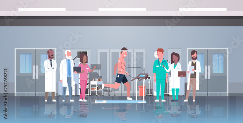 doctors group checking male patient running on treadmill with electrodes attached to body sports cardiology science concept EKG laboratory interior horizontal flat full length