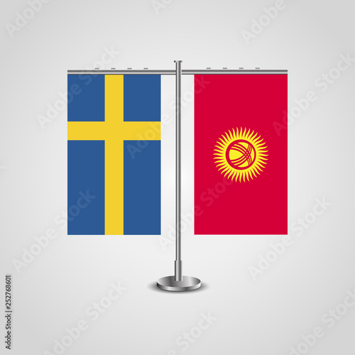 Table stand with flags of Sweden and Kyrgyzstan.Two flag. Flag pole. Symbolizing the cooperation between the two countries. Table flags