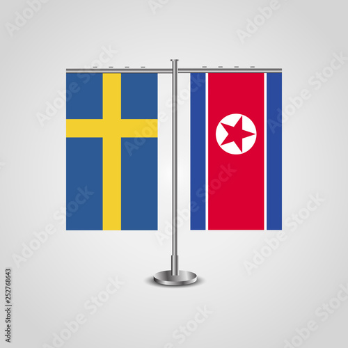 Table stand with flags of Sweden and North Korea.Two flag. Flag pole. Symbolizing the cooperation between the two countries. Table flags