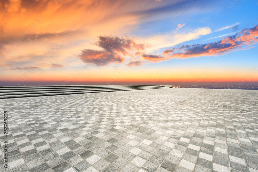 Empty square floor and modern city skyline with beautiful colorful clouds at sunset