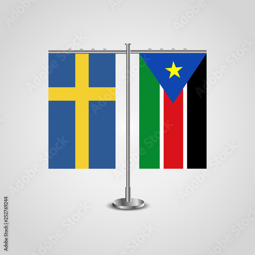 Table stand with flags of Sweden and Southern Sudan.Two flag. Flag pole. Symbolizing the cooperation between the two countries. Table flags