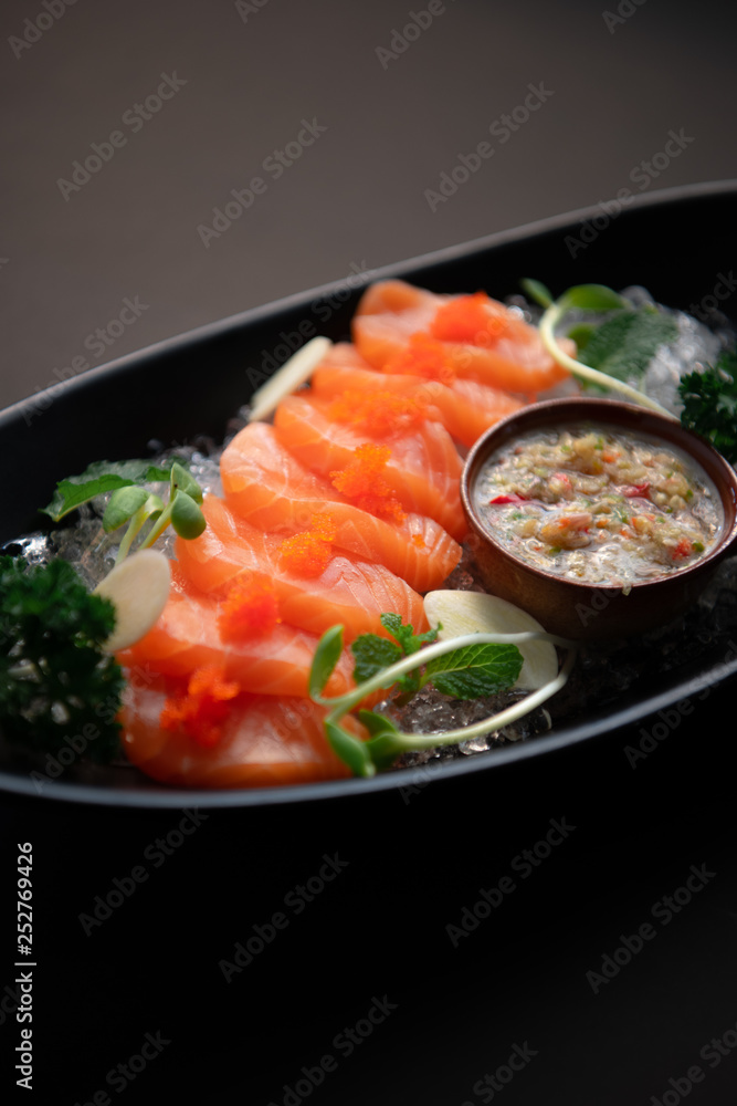 Salmon spicy On a black plate. Salmon spicy On a black background