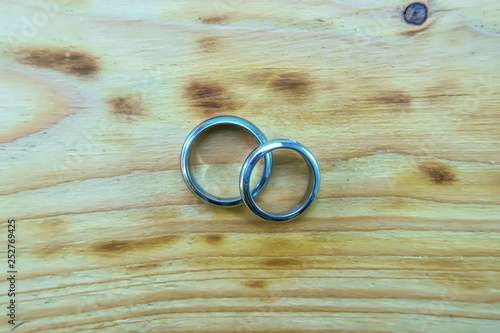 Silver ring on a wooden background.