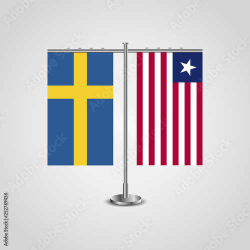 Table stand with flags of Sweden and Liberia.Two flag. Flag pole. Symbolizing the cooperation between the two countries. Table flags