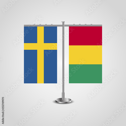 Table stand with flags of Sweden and Guinea.Two flag. Flag pole. Symbolizing the cooperation between the two countries. Table flags