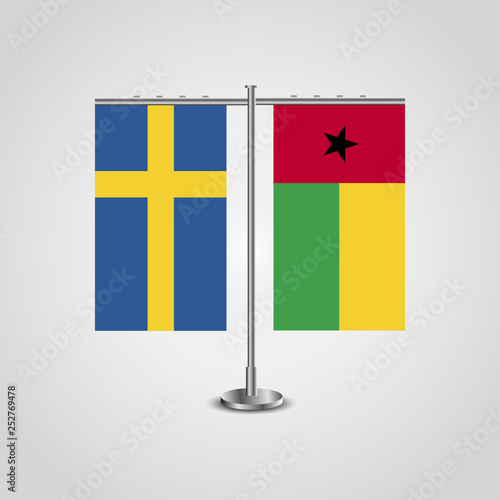 Table stand with flags of Sweden and Guinea-Bissau.Two flag. Flag pole. Symbolizing the cooperation between the two countries. Table flags