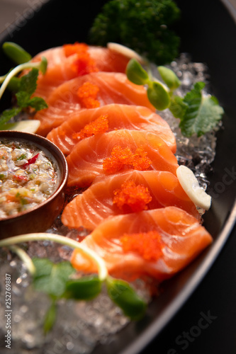 Salmon spicy On a black plate. Salmon spicy On a black background