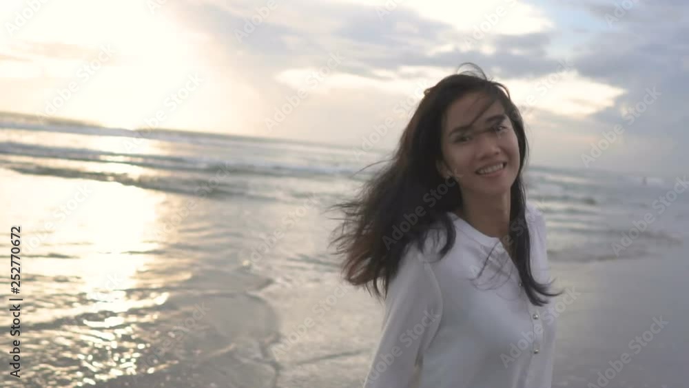 Happy cheerful woman having fun running to the sea Happy cheerful woman having fun running to the sea