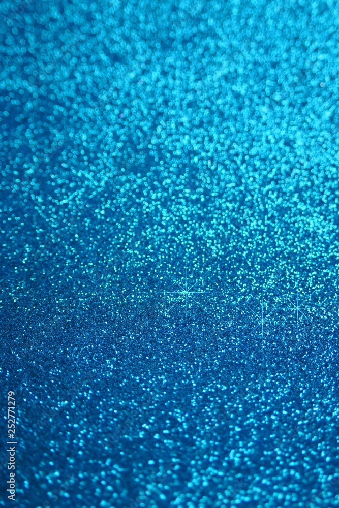 Fototapeta premium Glitter wallpaper. Glitter blue iridescent macro background with stars. Shiny backdrop.Snowy blue glitter shiny abstract Background.