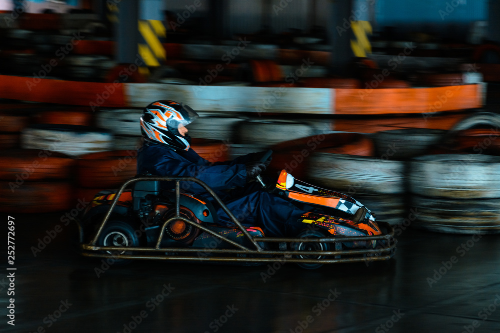 Dynamic karting competition at speed with blurry motion on an equipped racecourse Dynamic karting competition at speed with blurry motion on an equipped racecourse