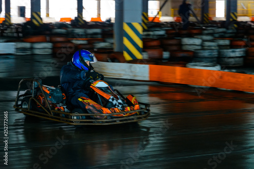 Dynamic karting competition at speed with blurry motion on an equipped racecourse © Niko_Dali