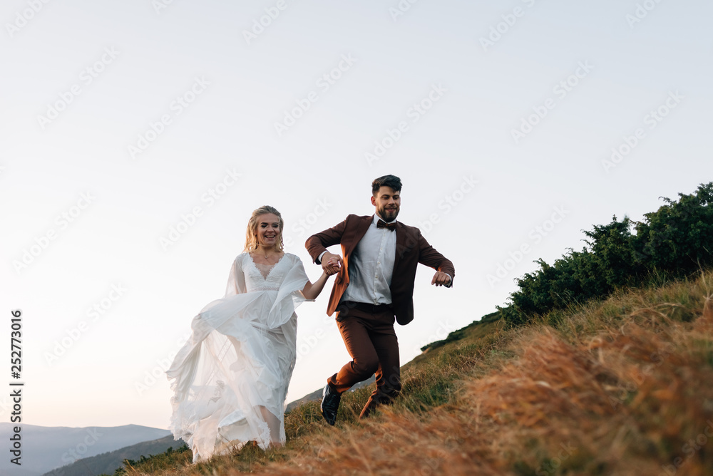 Romantic wedding trip of spouses in love in the mountains. Romantic wedding trip of spouses in love in the mountains.
