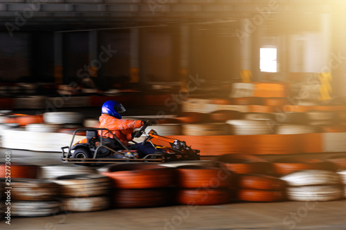 Dynamic karting competition at speed with blurry motion on an equipped racecourse © Niko_Dali