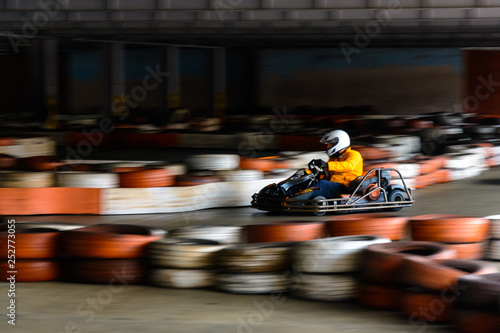 Dynamic karting competition at speed with blurry motion on an equipped racecourse