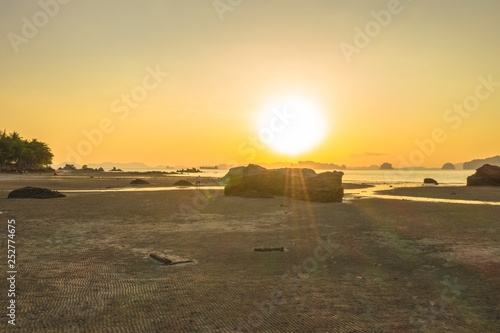 Tup Kaek beach close to Kwang beach and non Nak mountain during low tide .can see long and large beach can walk around many big rocks on the beach .beautiful sunset behind archipelago in Andaman sea photo