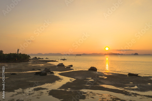 Tup Kaek beach close to Kwang beach and non Nak mountain during low tide .can see long and large beach can walk around many big rocks on the beach .beautiful sunset behind archipelago in Andaman sea photo